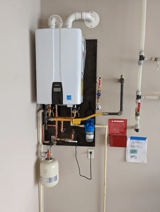 Professional plumber installing copper piping in a Worcester home